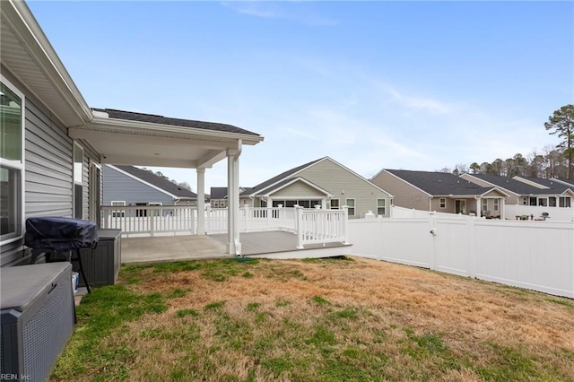 view of yard with a patio area, a residential view, and a fenced backyard