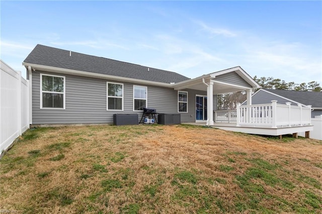 rear view of property featuring a lawn