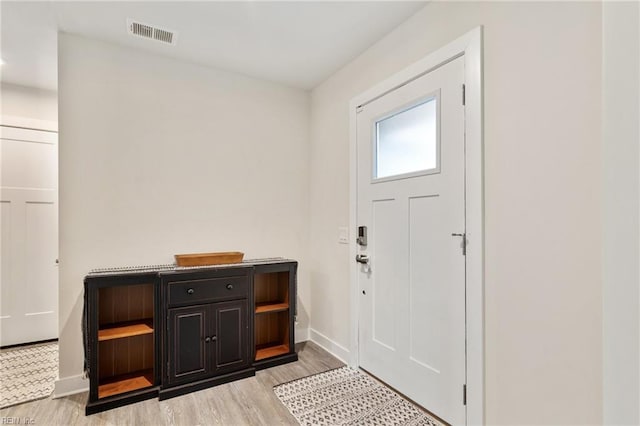 entryway featuring visible vents, light wood-type flooring, and baseboards