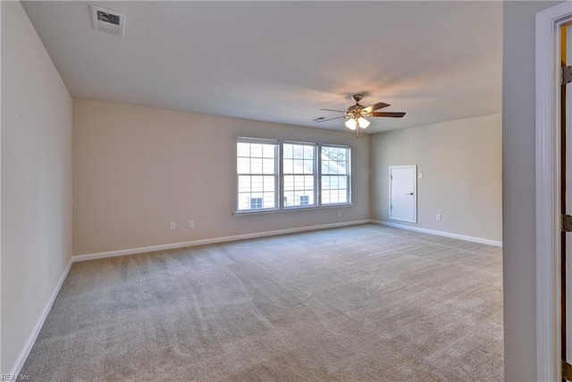 unfurnished room featuring a ceiling fan, carpet, visible vents, and baseboards