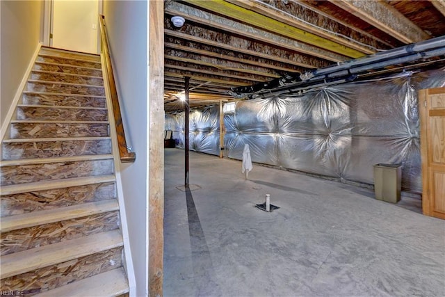 unfinished basement featuring stairs