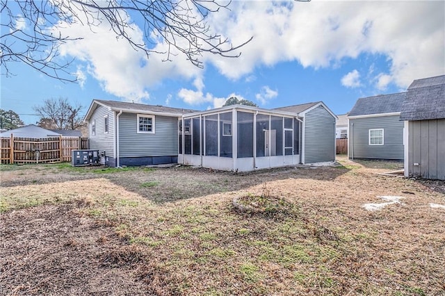 rear view of property with a sunroom and fence