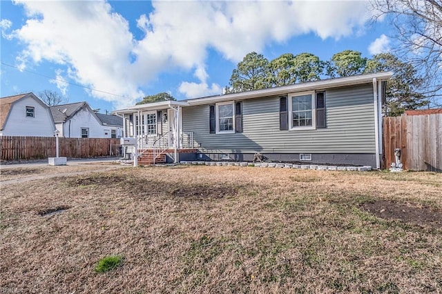 view of front of house with a front lawn, crawl space, and fence