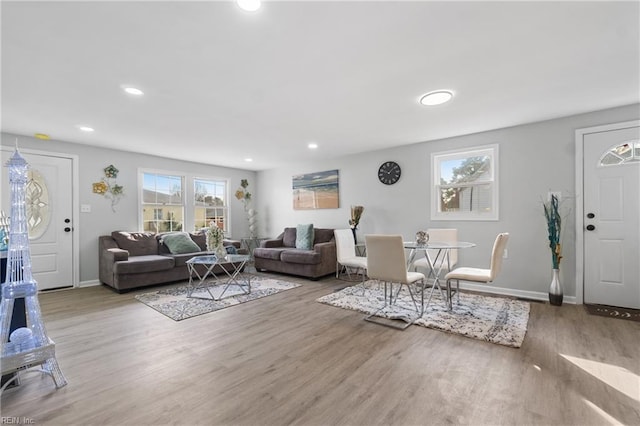 living area with recessed lighting, baseboards, and wood finished floors