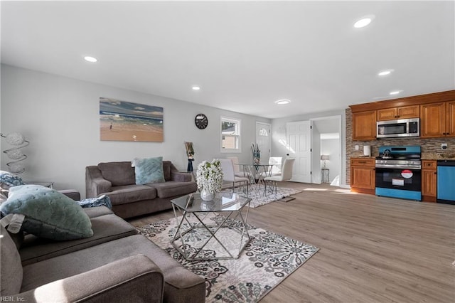 living room with light wood-style floors and recessed lighting