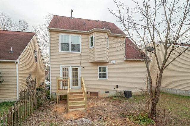 rear view of property with central AC, a shingled roof, and fence