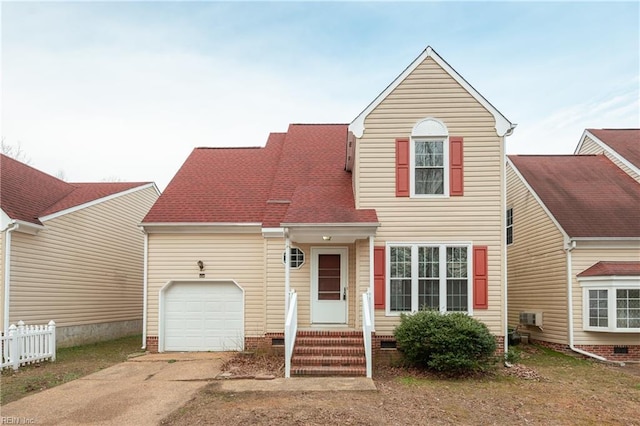 traditional home featuring concrete driveway, roof with shingles, crawl space, an attached garage, and fence