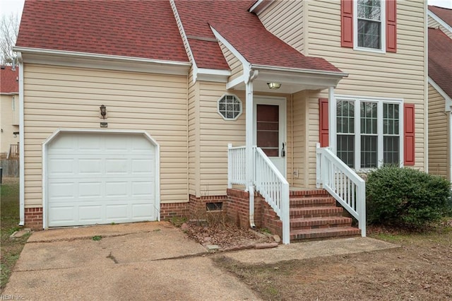 exterior space featuring a garage, concrete driveway, and a shingled roof