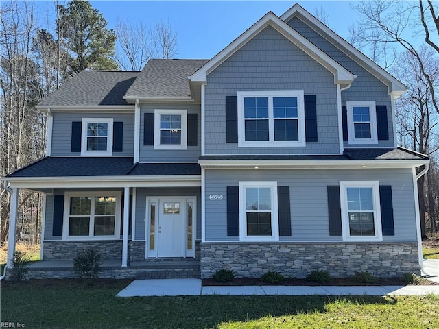 craftsman-style house with stone siding, a shingled roof, and a porch