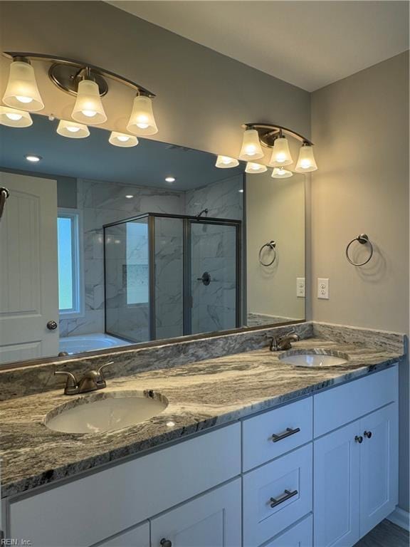 full bath with double vanity, a garden tub, a shower stall, and a sink