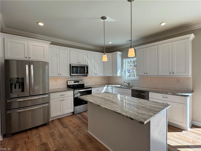 kitchen featuring dark wood-style floors, white cabinetry, ornamental molding, and stainless steel appliances