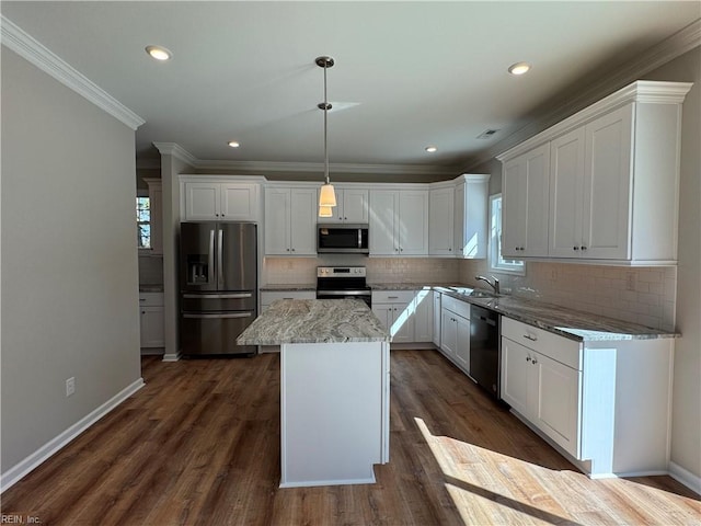 kitchen featuring white cabinets, a kitchen island, stainless steel appliances, and dark wood finished floors