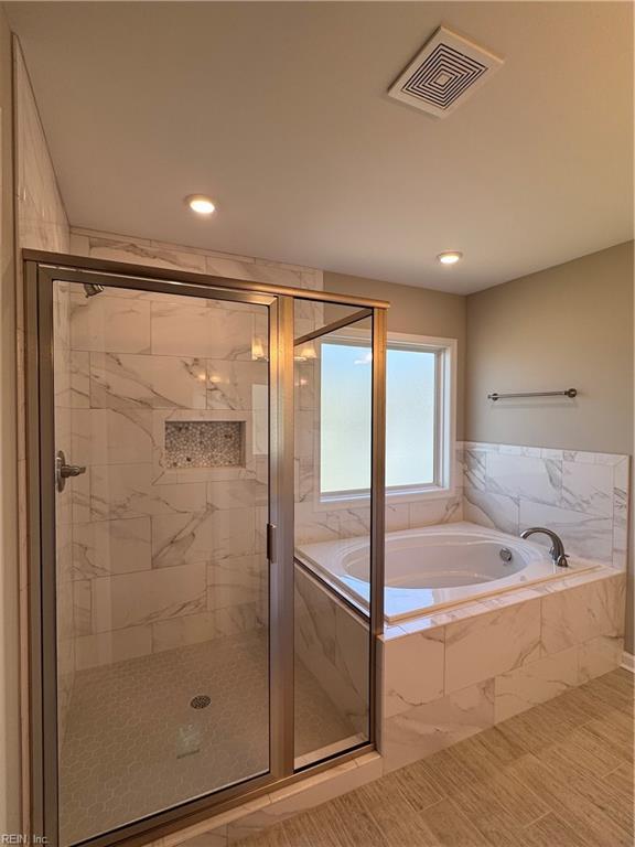 full bathroom featuring a garden tub, a shower stall, visible vents, and recessed lighting