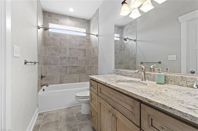 bathroom with tile patterned flooring, toilet, vanity, baseboards, and shower / bathing tub combination