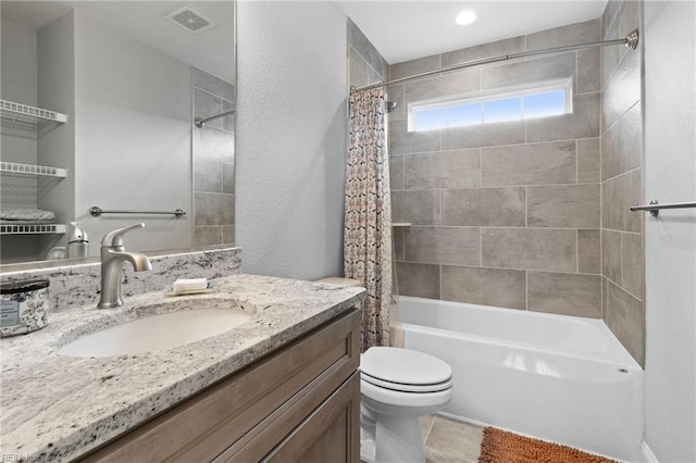 bathroom featuring toilet, visible vents, shower / bath combo with shower curtain, and vanity