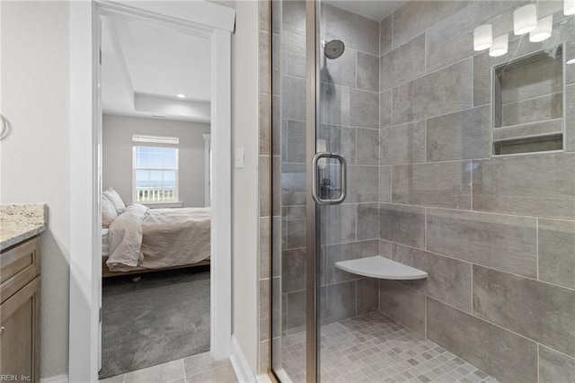 full bathroom featuring a stall shower, tile patterned flooring, vanity, and ensuite bathroom