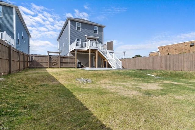 back of house featuring a fenced backyard, a yard, stairway, a wooden deck, and a gate