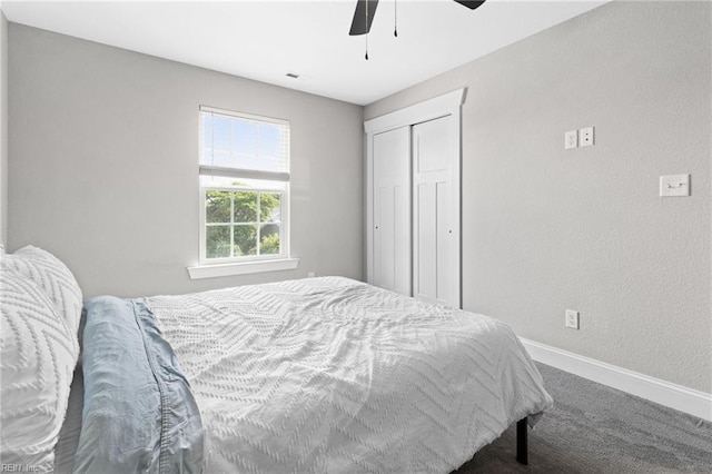 bedroom featuring carpet floors, a closet, baseboards, and a ceiling fan