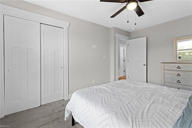 bedroom with carpet floors, a closet, and a ceiling fan