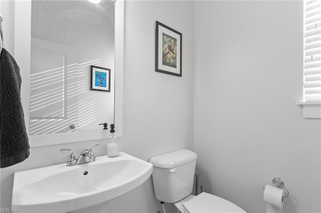 half bath featuring a sink and toilet