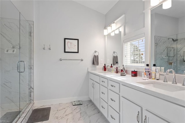 bathroom with marble finish floor, a marble finish shower, baseboards, and a sink