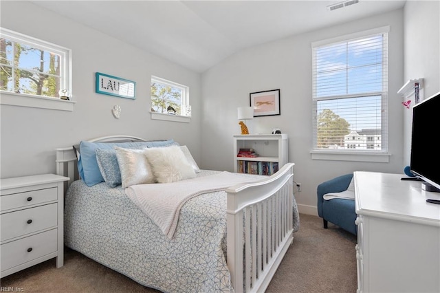 bedroom with carpet, visible vents, and vaulted ceiling