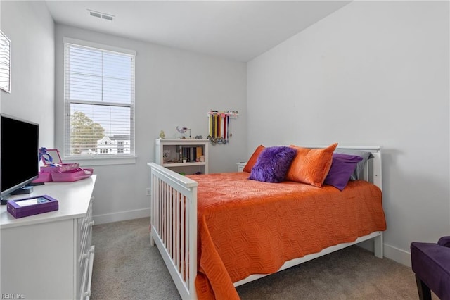 bedroom featuring light carpet, visible vents, and baseboards