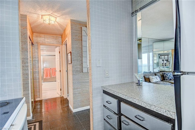 bathroom featuring tile walls, a textured ceiling, and vanity