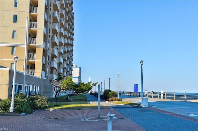 view of street featuring street lights, curbs, and a view of city