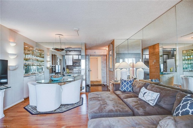 living room with a textured ceiling and wood finished floors