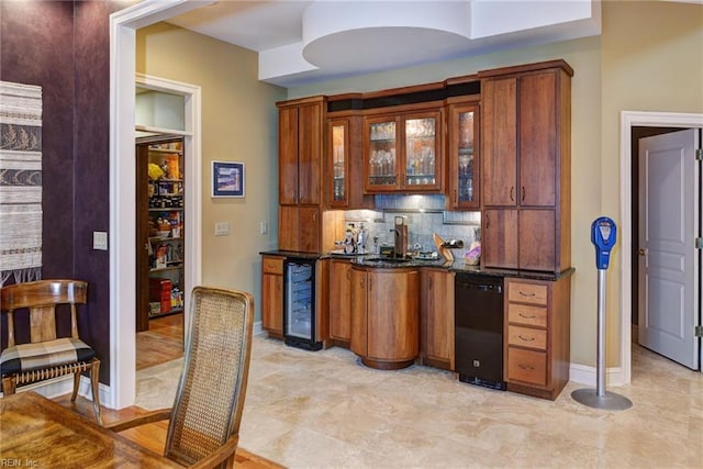 bar featuring beverage cooler, backsplash, black dishwasher, indoor wet bar, and baseboards