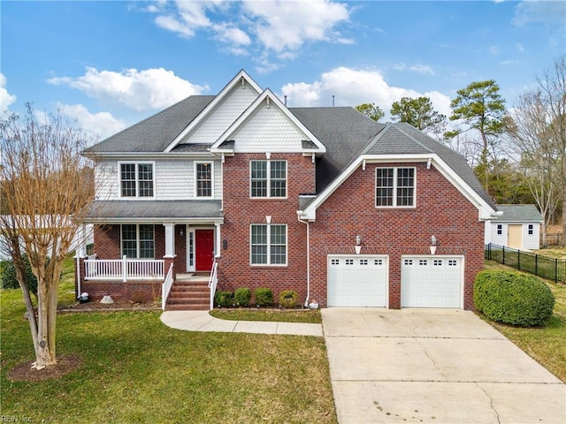 view of front of property featuring a porch, brick siding, fence, concrete driveway, and a front lawn