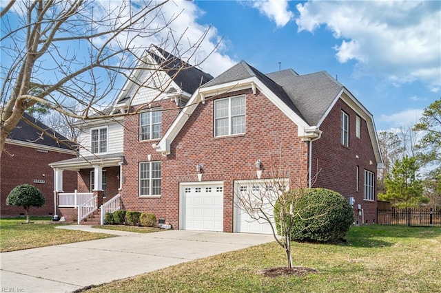 view of front facade with driveway, fence, a front lawn, and brick siding