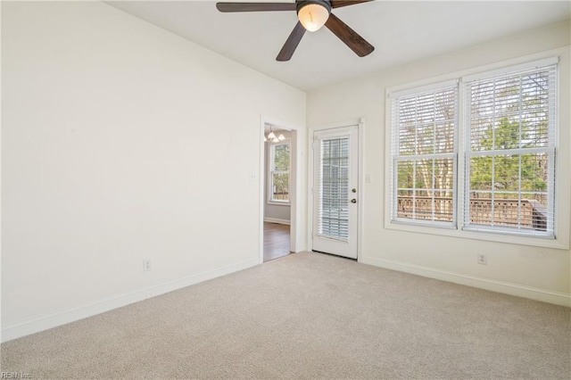 unfurnished room with a healthy amount of sunlight, carpet flooring, and baseboards