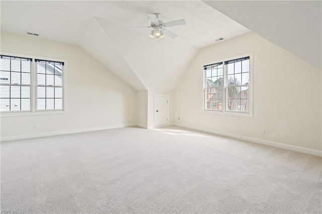 bonus room with a ceiling fan, lofted ceiling, carpet flooring, and baseboards