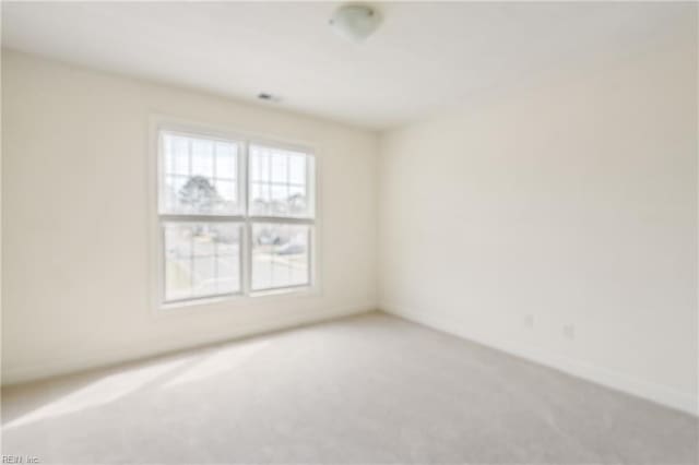 unfurnished room with light colored carpet