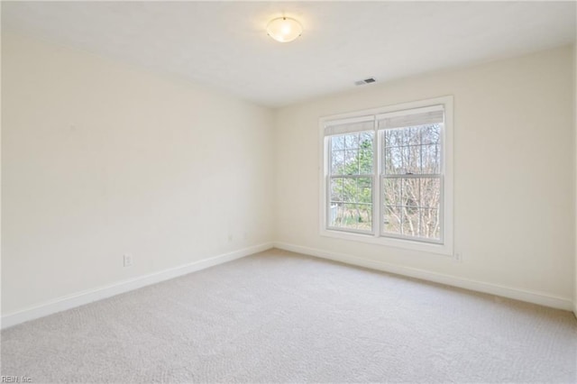 carpeted empty room with baseboards