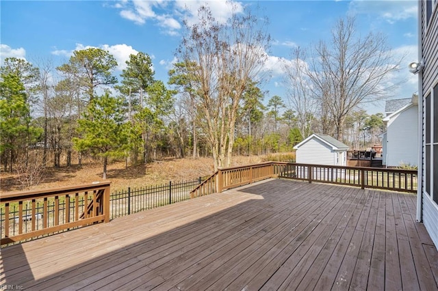 wooden terrace featuring an outdoor structure