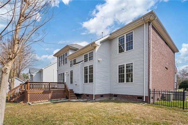 back of property featuring crawl space, fence, a deck, and a yard