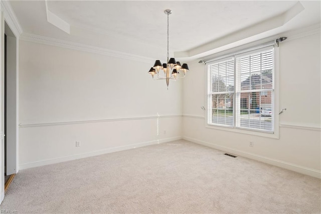 unfurnished room with a raised ceiling, visible vents, a notable chandelier, and carpet flooring