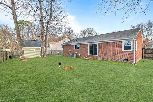 rear view of house featuring entry steps, brick siding, central AC unit, and an outdoor structure