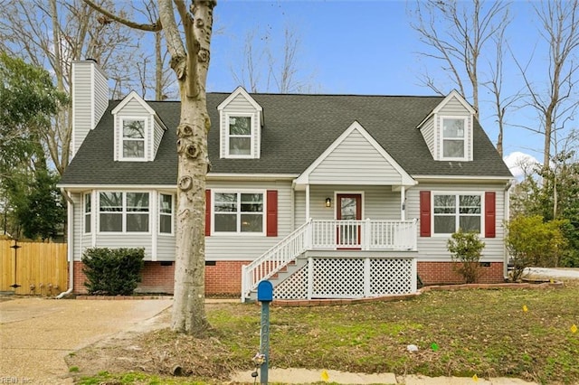 cape cod house featuring a shingled roof, crawl space, fence, and a front lawn