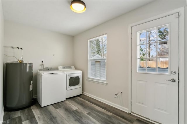 laundry area featuring laundry area, wood finished floors, baseboards, water heater, and independent washer and dryer