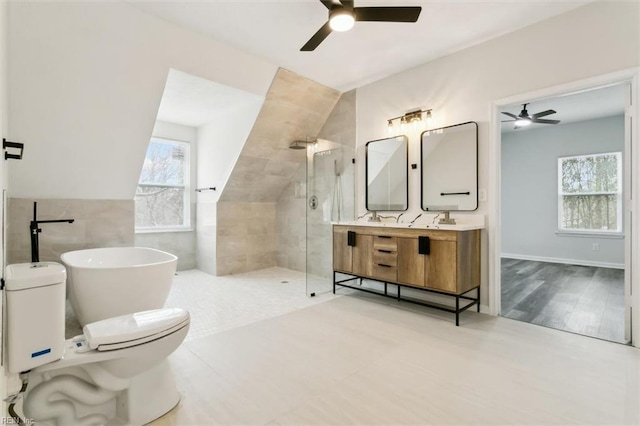 full bath featuring double vanity, toilet, a soaking tub, walk in shower, and tile walls