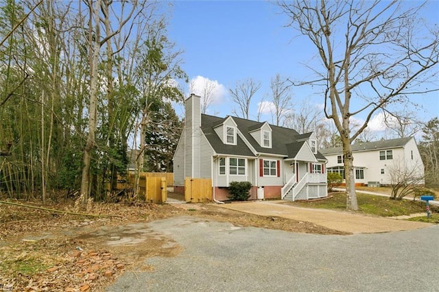 new england style home featuring crawl space and a chimney