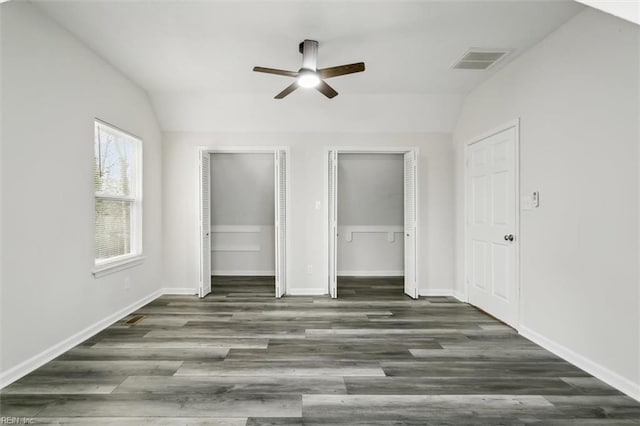 interior space featuring visible vents, vaulted ceiling, and wood finished floors