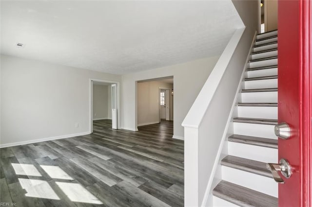 interior space featuring visible vents, stairs, baseboards, and wood finished floors