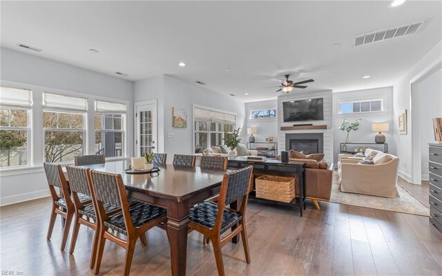 dining area featuring visible vents, a healthy amount of sunlight, and a fireplace