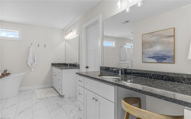 full bath featuring a sink, baseboards, two vanities, and marble finish floor