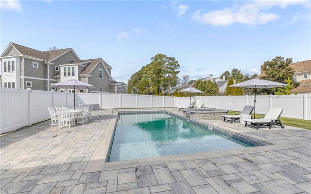 view of swimming pool with a fenced in pool, a patio, a fenced backyard, and a hot tub